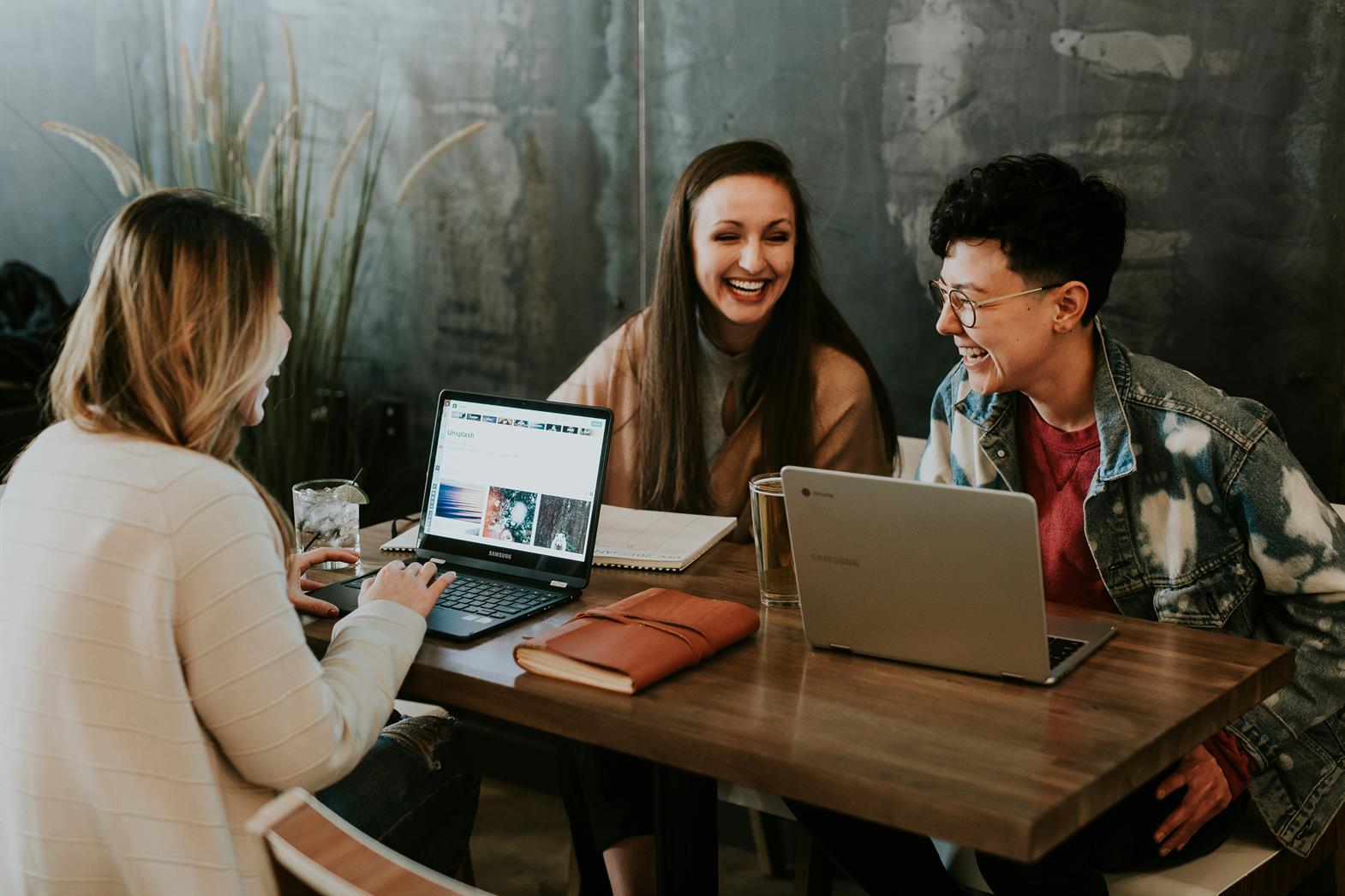 Three friends working together at a table