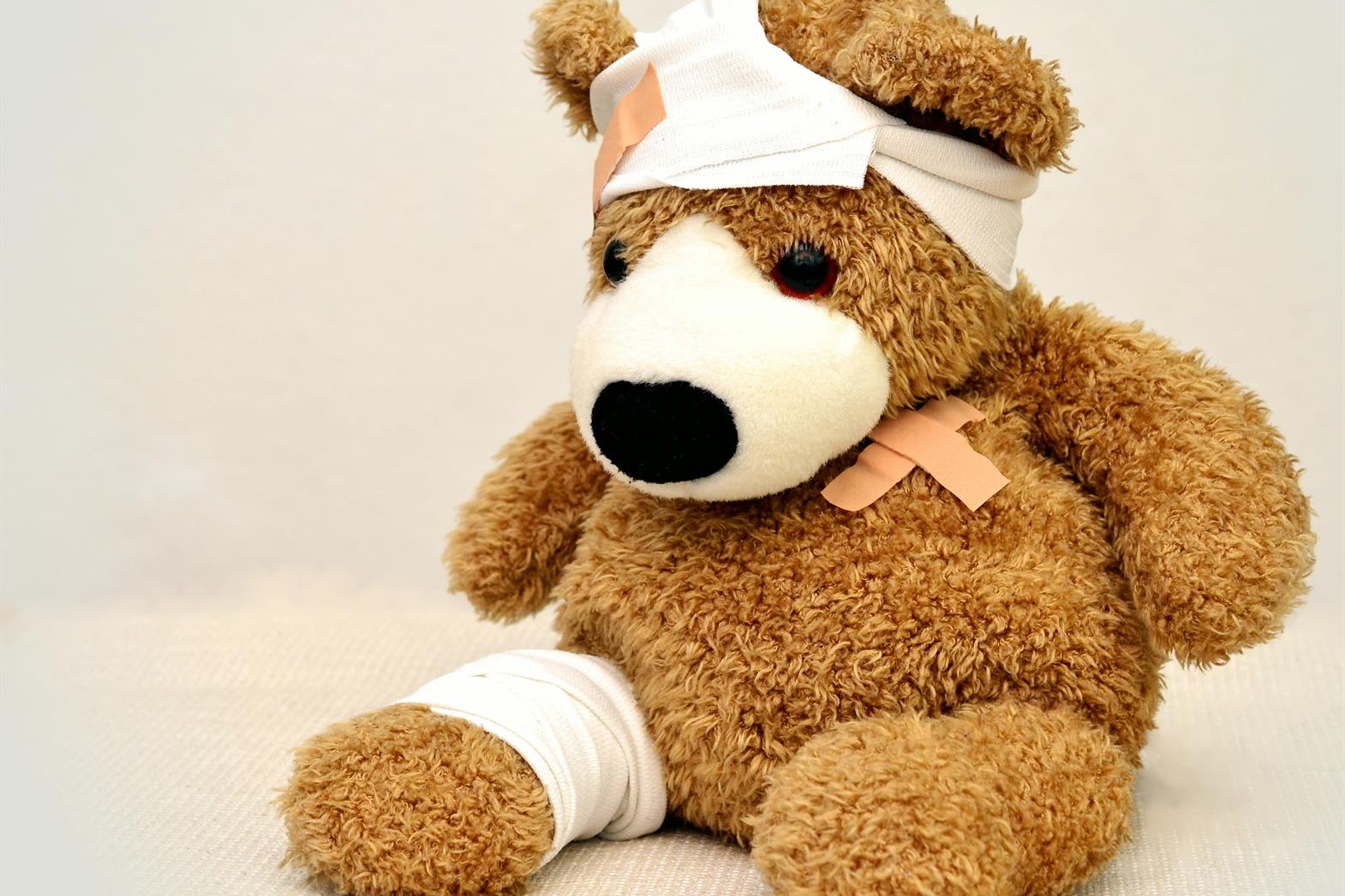 A teddy bear wearing a bandage