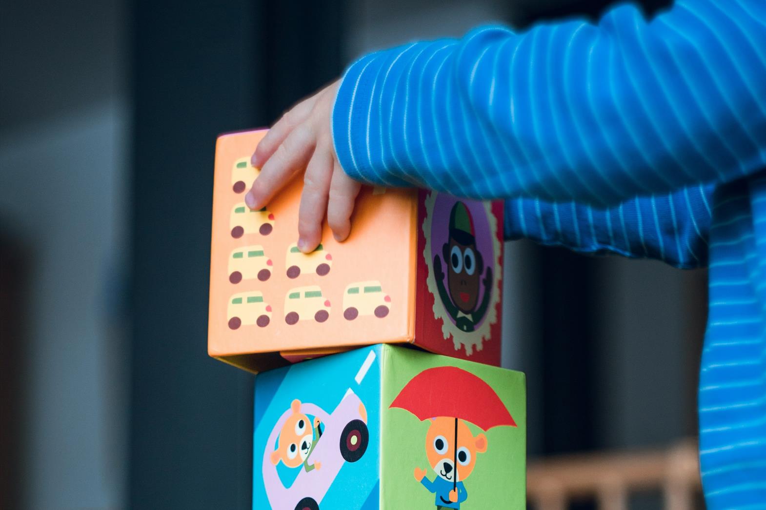 A child stacking blocks
