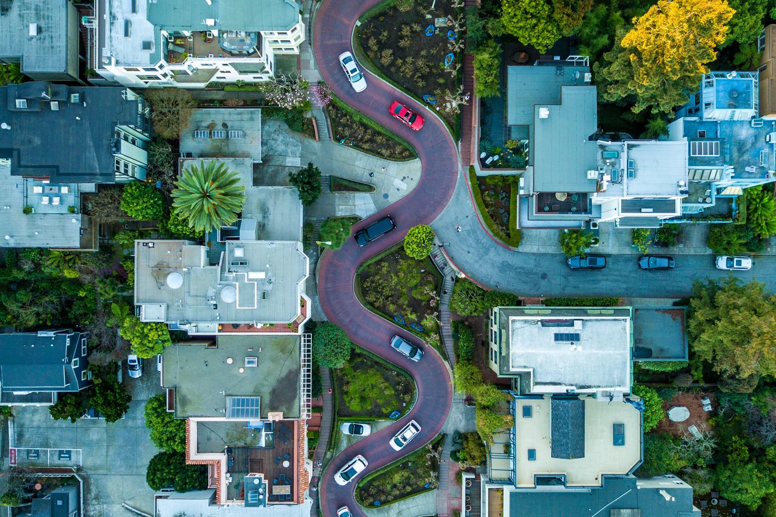A winding road going through a neighborhood