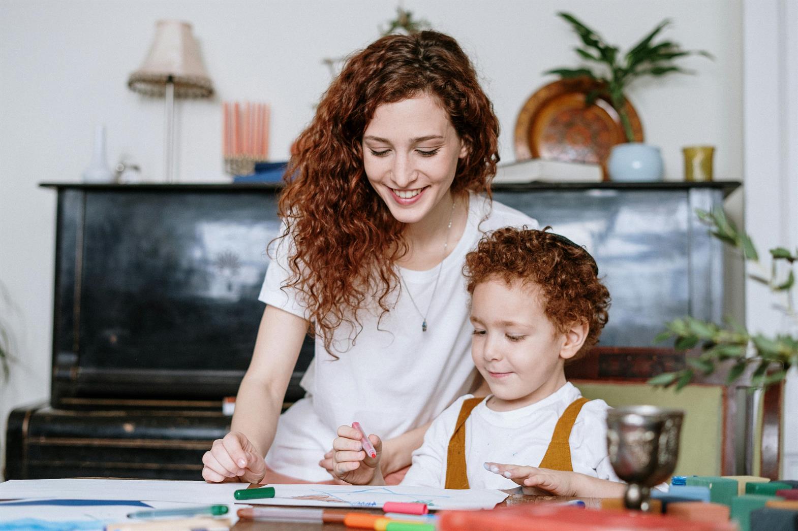 a mother and child doing arts and crafts together