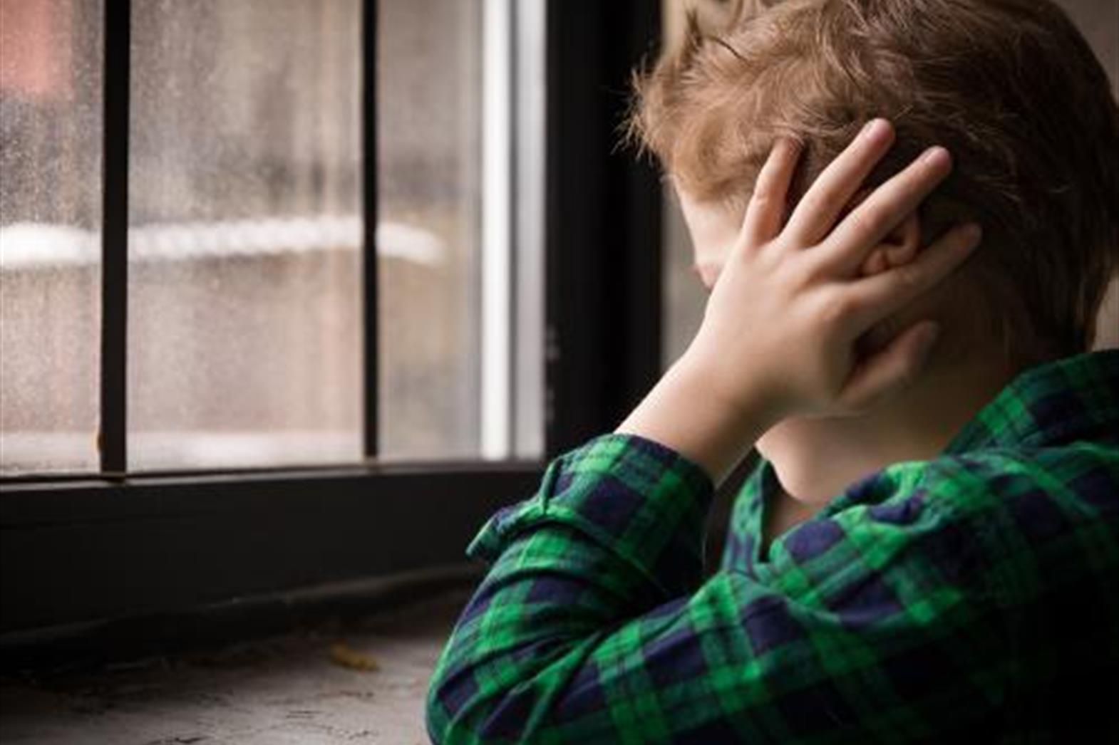 child covering his ears