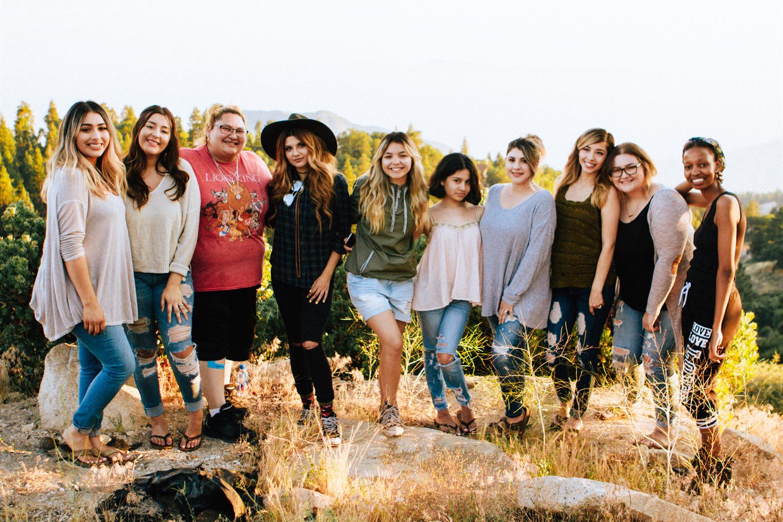 10 people standing in a row smiling