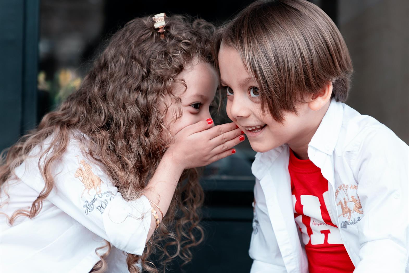 Two children whispering together