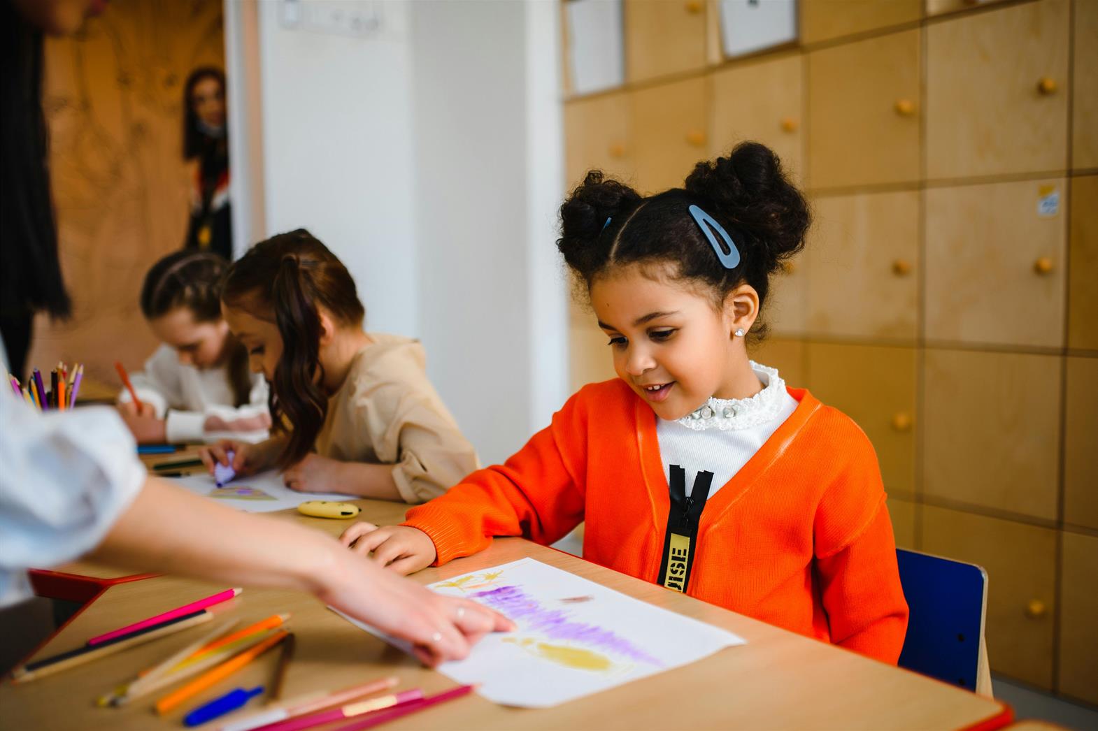 Girl Sitting in a Classroom Looking at Artwork