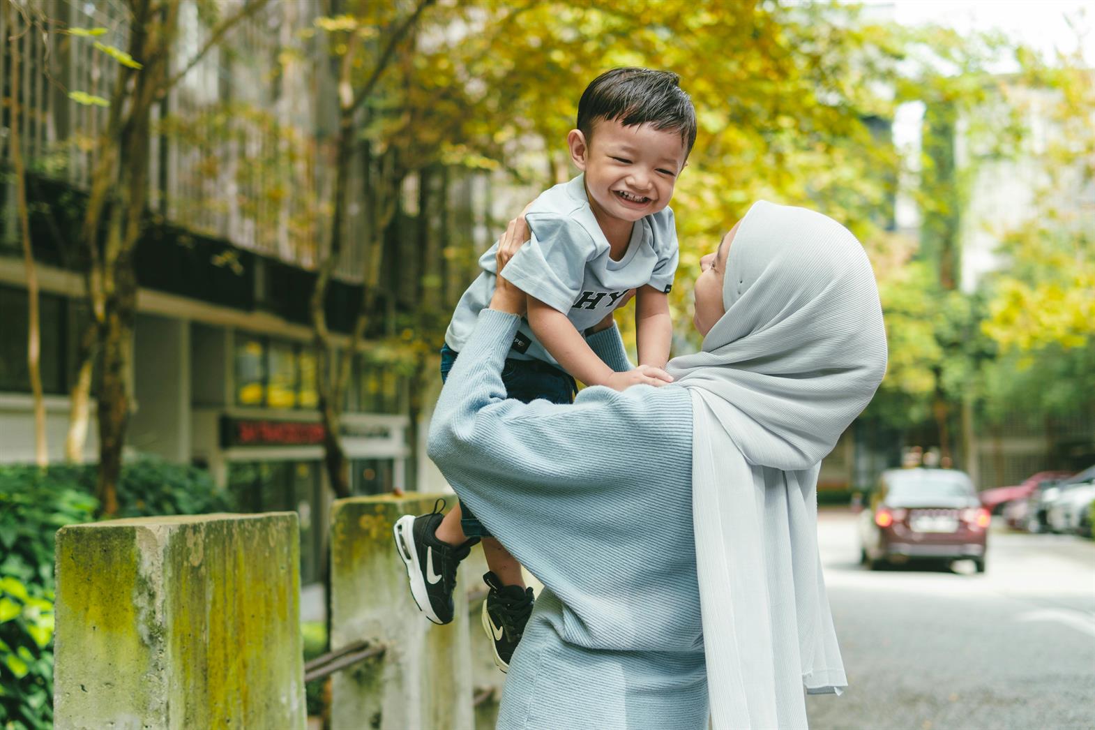 A woman holding a young boy