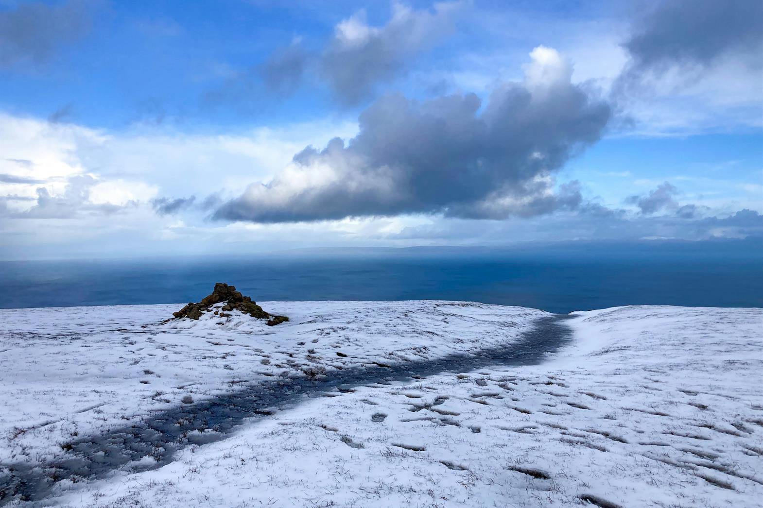 A snowy path by the sea