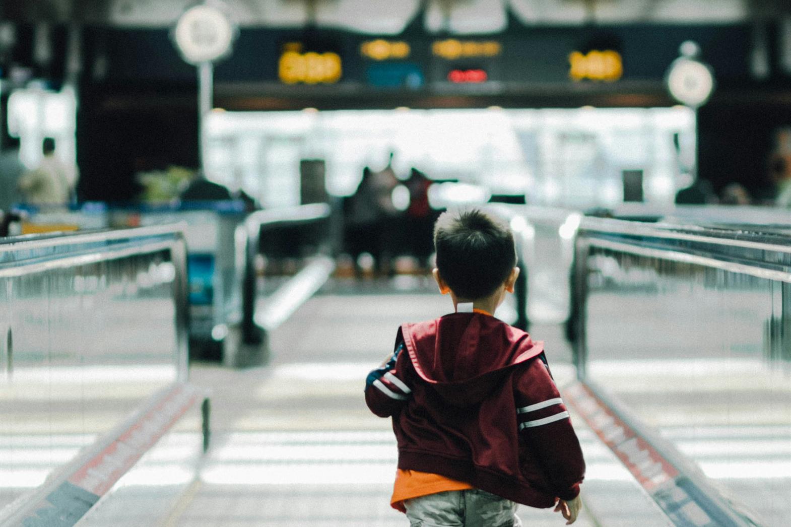 A boy running in the airport