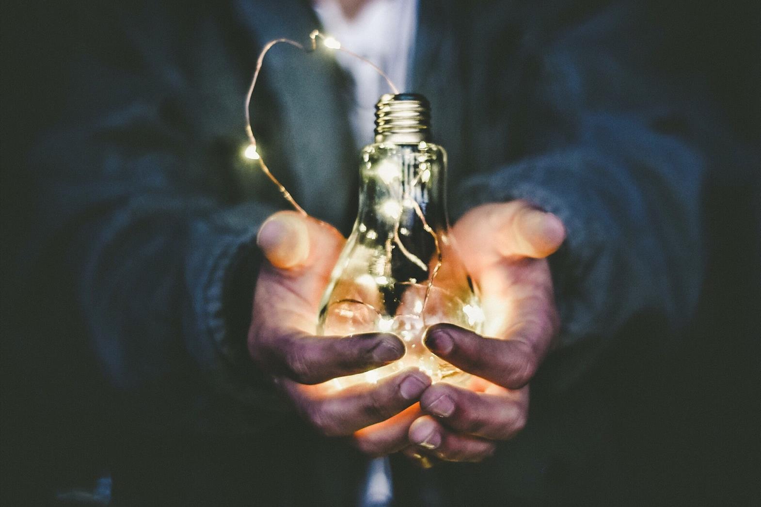 man holding a light bulb