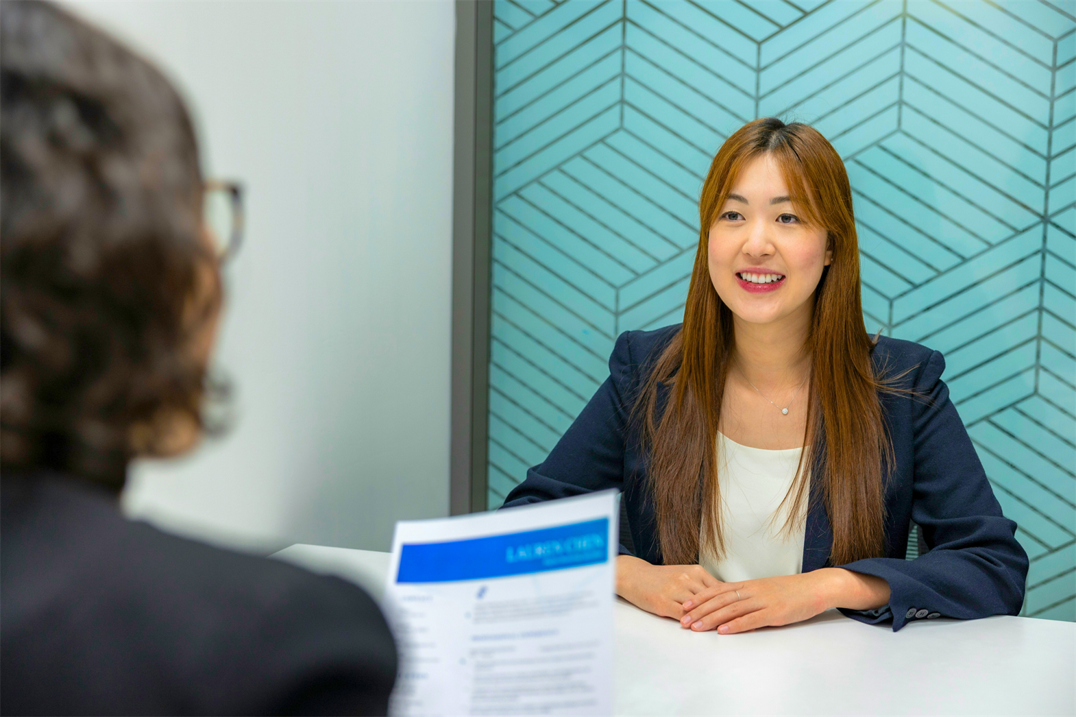 A woman having her resume reviewed at a job interview