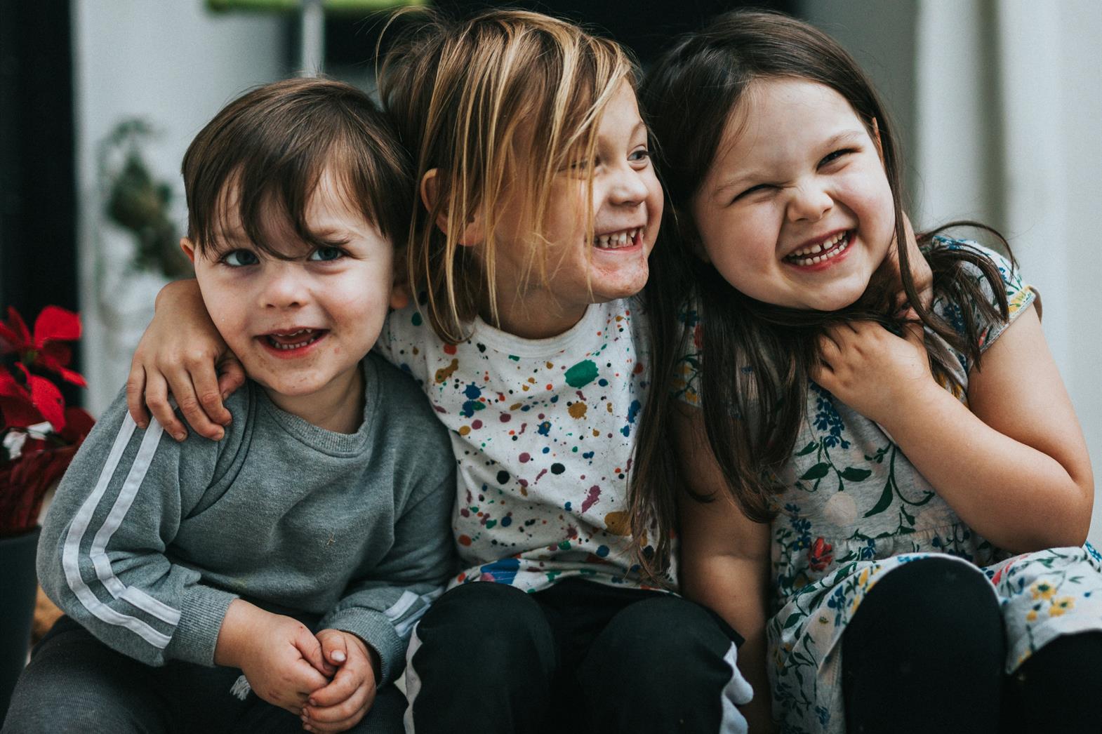 three children laughing together