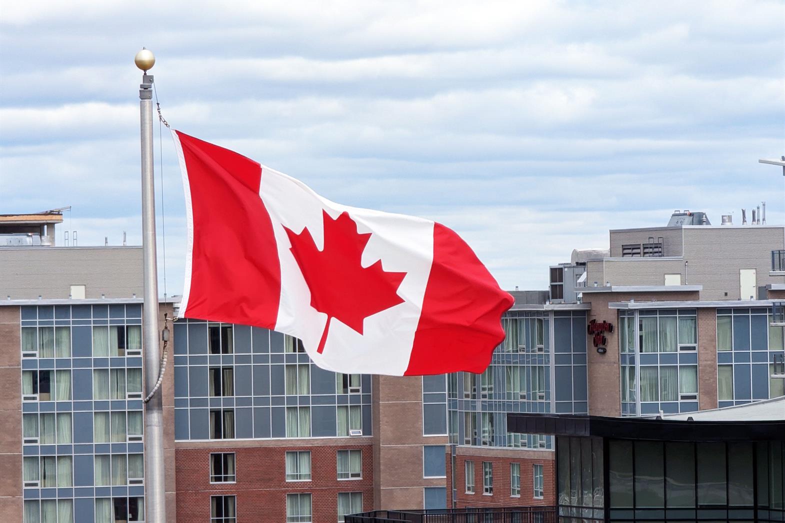 A Canadian flag in front of a building