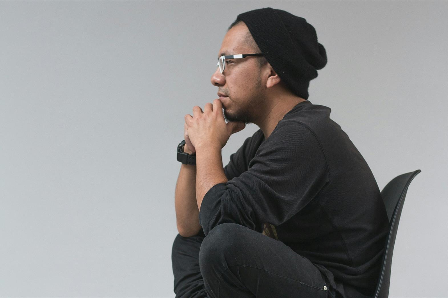 A man sitting in a chair thinking deeply