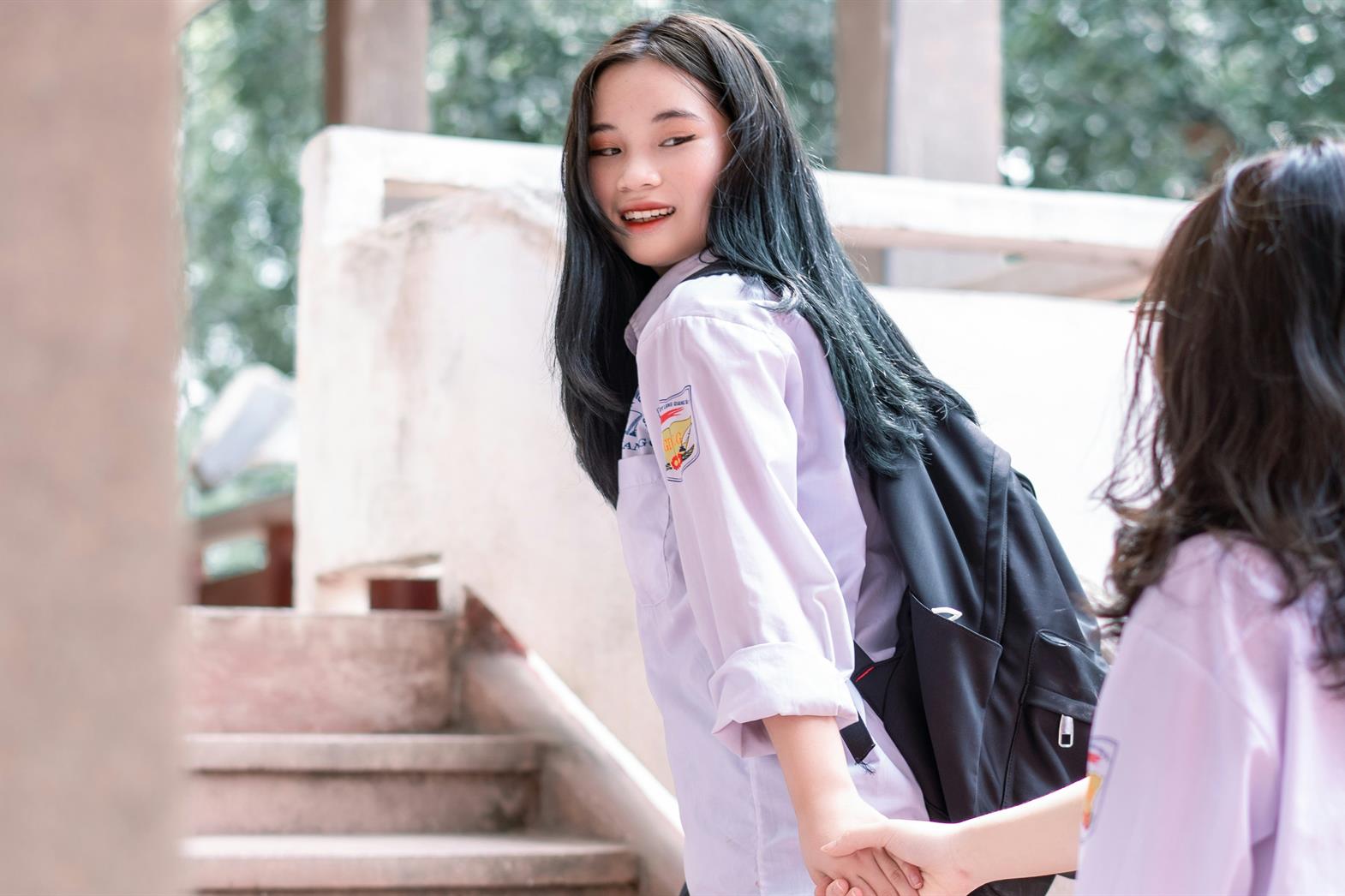two sisters walking up the stairs together at school